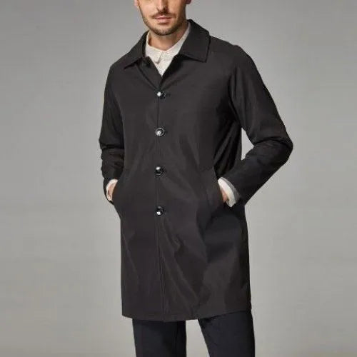 Man wearing a khaki coloured loose fit mid-length trench coat made from rabbit fur fabric.