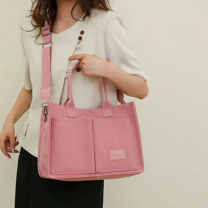 Premium canvas tote bag with multiple pockets, adjustable shoulder strap, and stylish design for everyday use