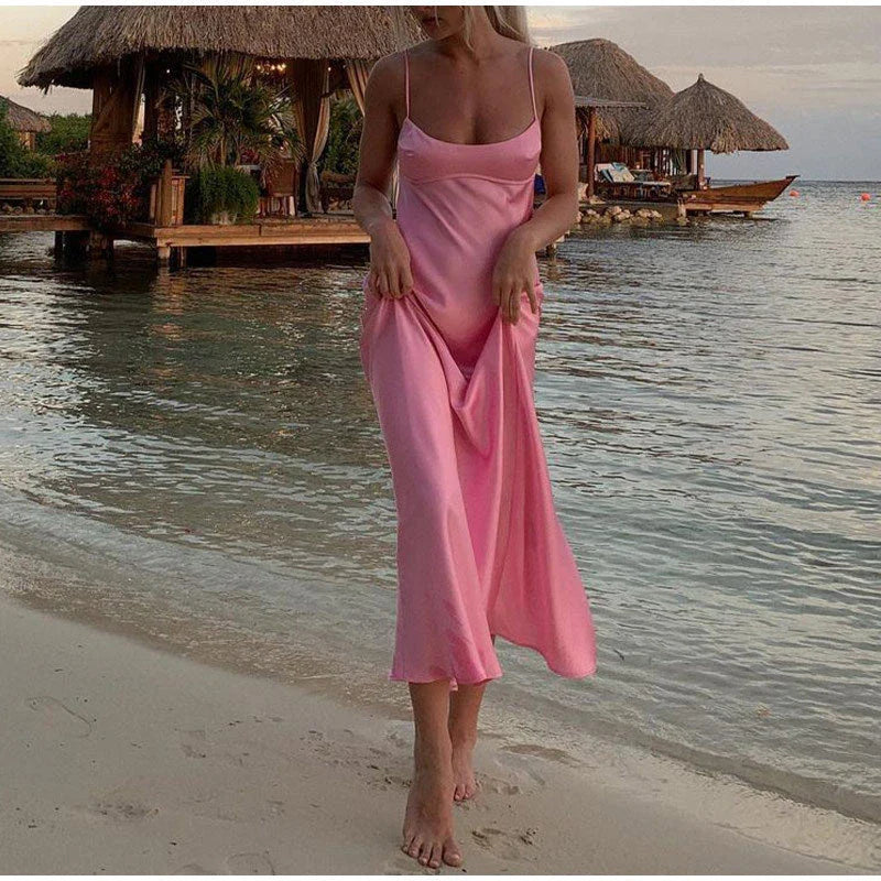 Elegant satin slip dress in pink with a square neckline, sleeveless design, and backless detail