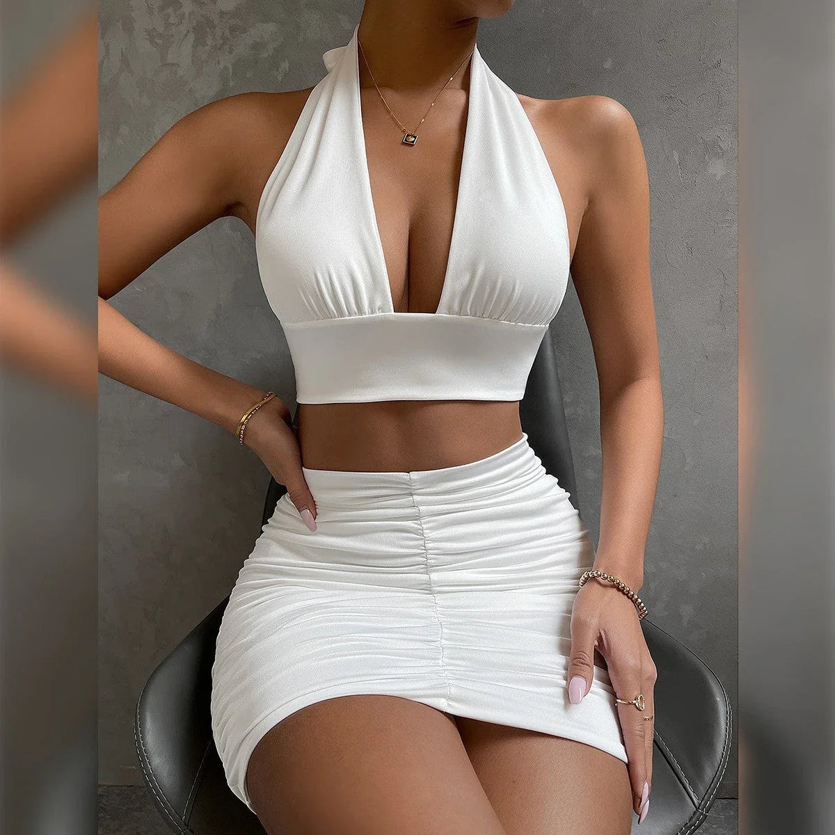 Elegant 2-piece dress suit featuring a halter lace-up top and pleated knee-length skirt in a variety of fashion colors