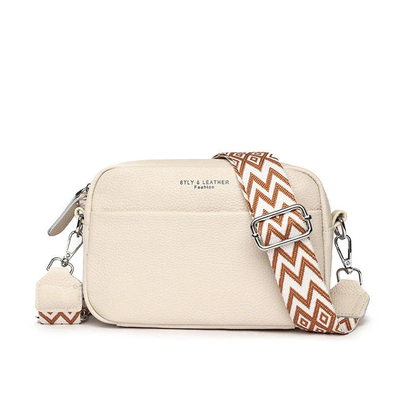Stylish crossbody bag with rhombus embroidery, wide adjustable shoulder strap, and multiple interior pockets in various color options