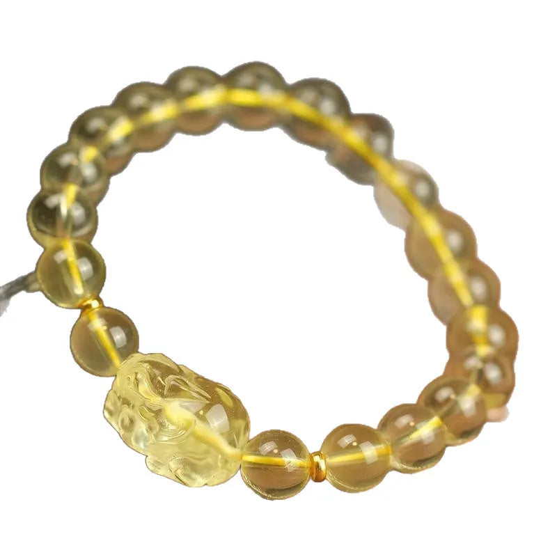 Yellow artificial crystal Pi Xiu charm on a leather bracelet, shown with different bead size options.