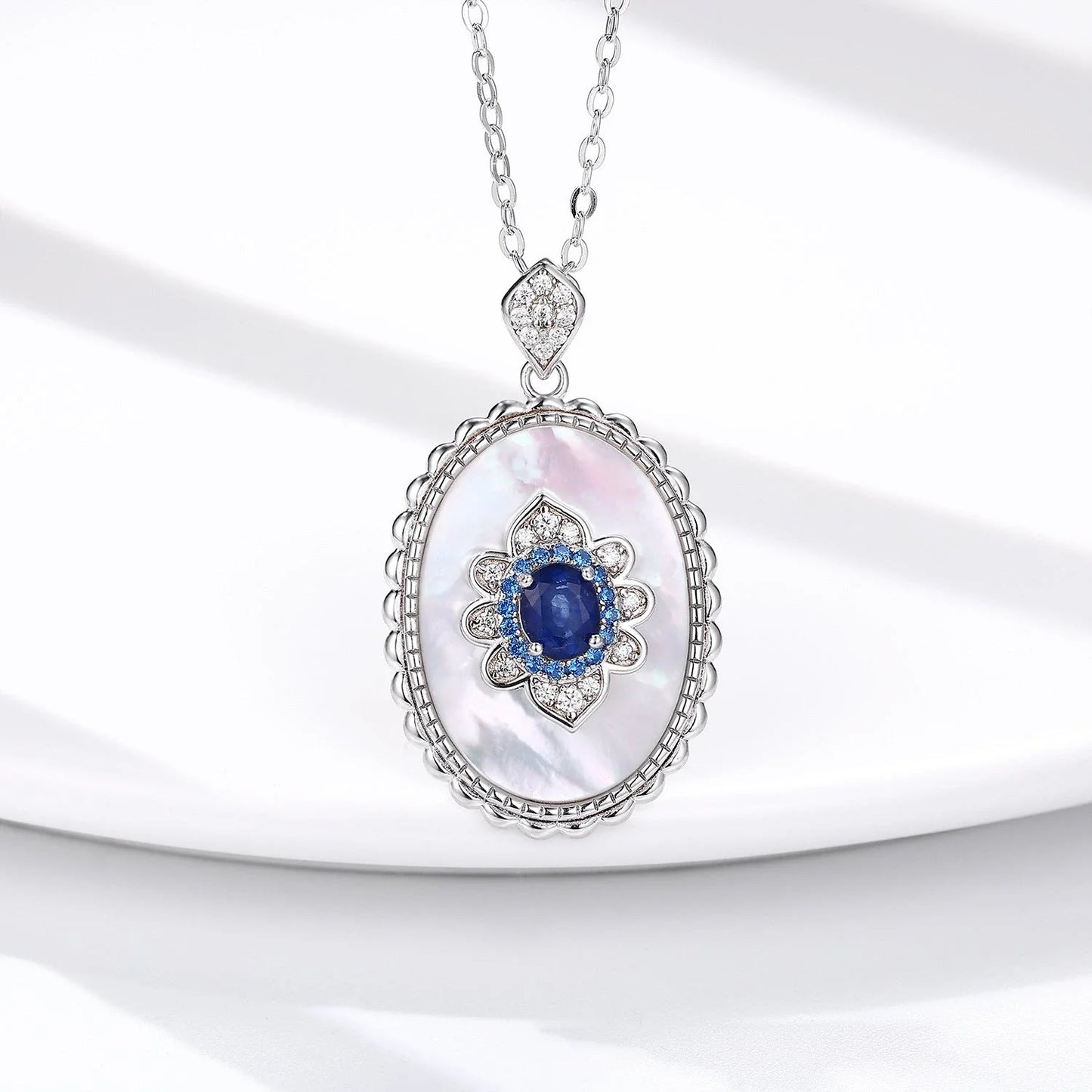 Elegant sapphire and diamond pendant necklace in 925 sterling silver, featuring a sparkling gemstone design and adjustable chain.