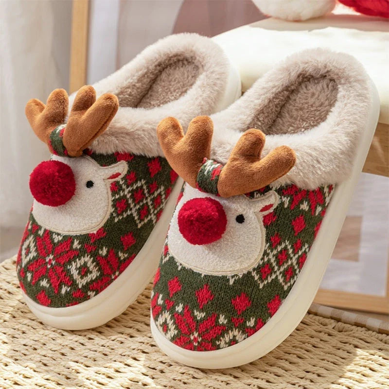 Cozy elk-themed Christmas slippers in green and red colors, featuring a plush, fuzzy design and non-slip sole for comfortable indoor wear
