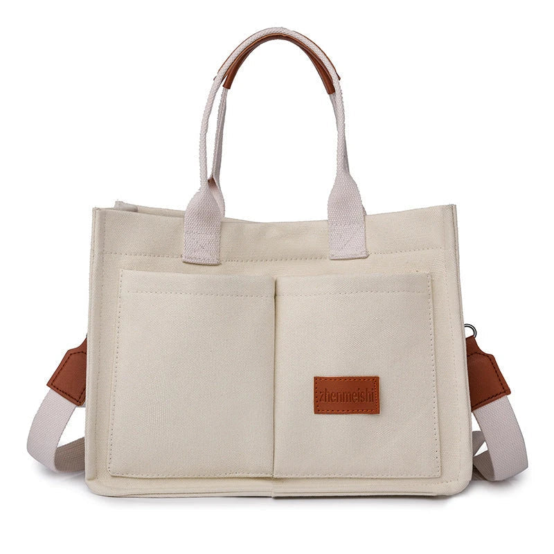 Premium canvas tote bag with multiple pockets, adjustable shoulder strap, and stylish design for everyday use