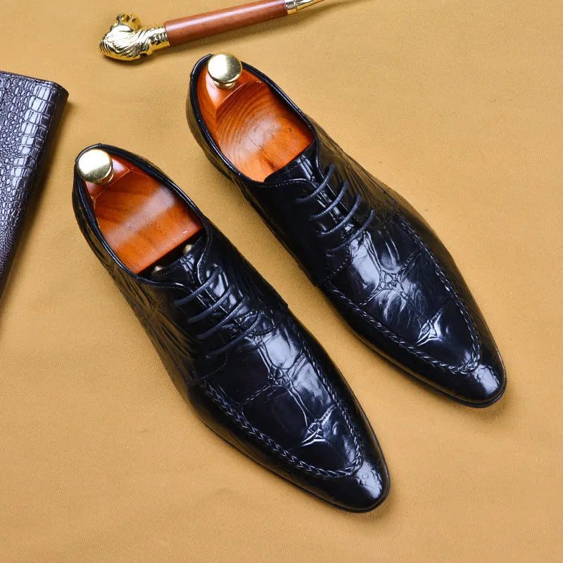 Black men's leather casual shoes with alligator pattern and metal horse bit buckle on a rubber sole.