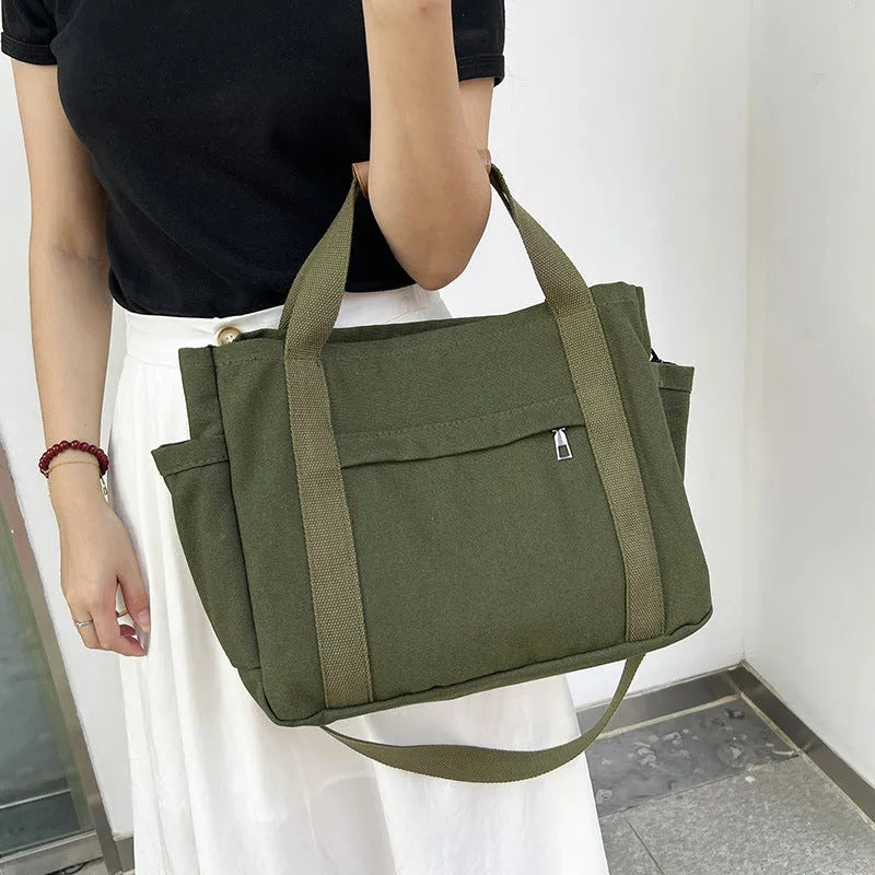 Large canvas tote bag in horizontal square shape with open-zip sides and internal organisers