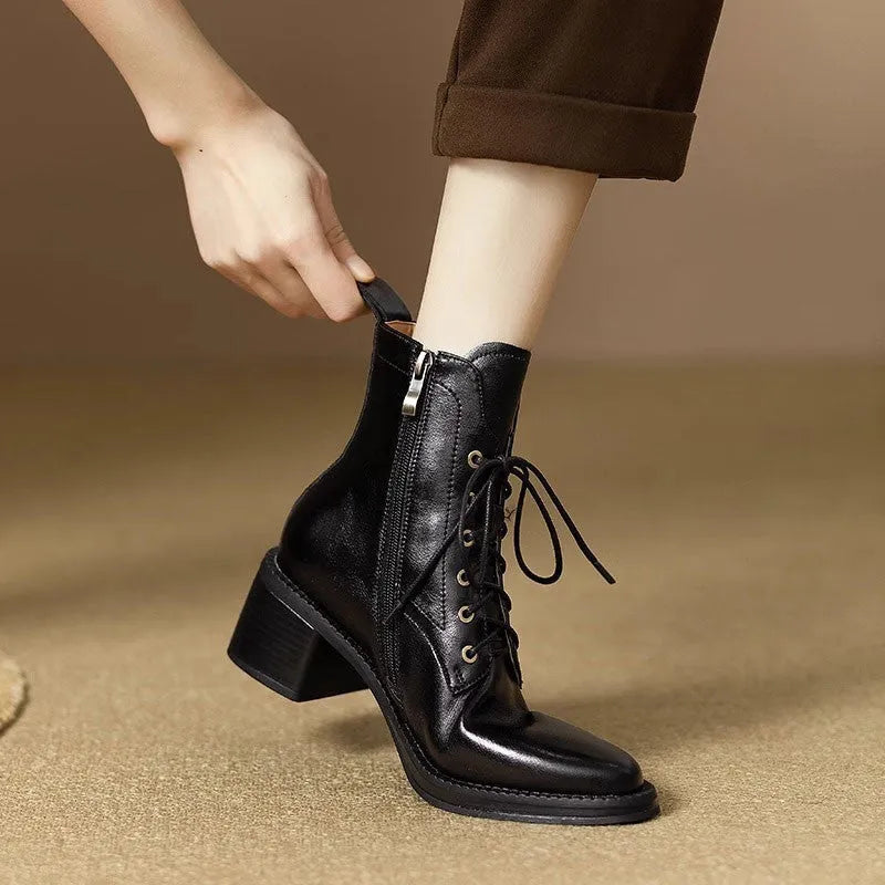 Women's black pointed toe short tube boots with a 5.5cm heel on a white background.