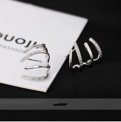Pair of 925 sterling silver earrings with four-prong zircon stone settings in a geometric design