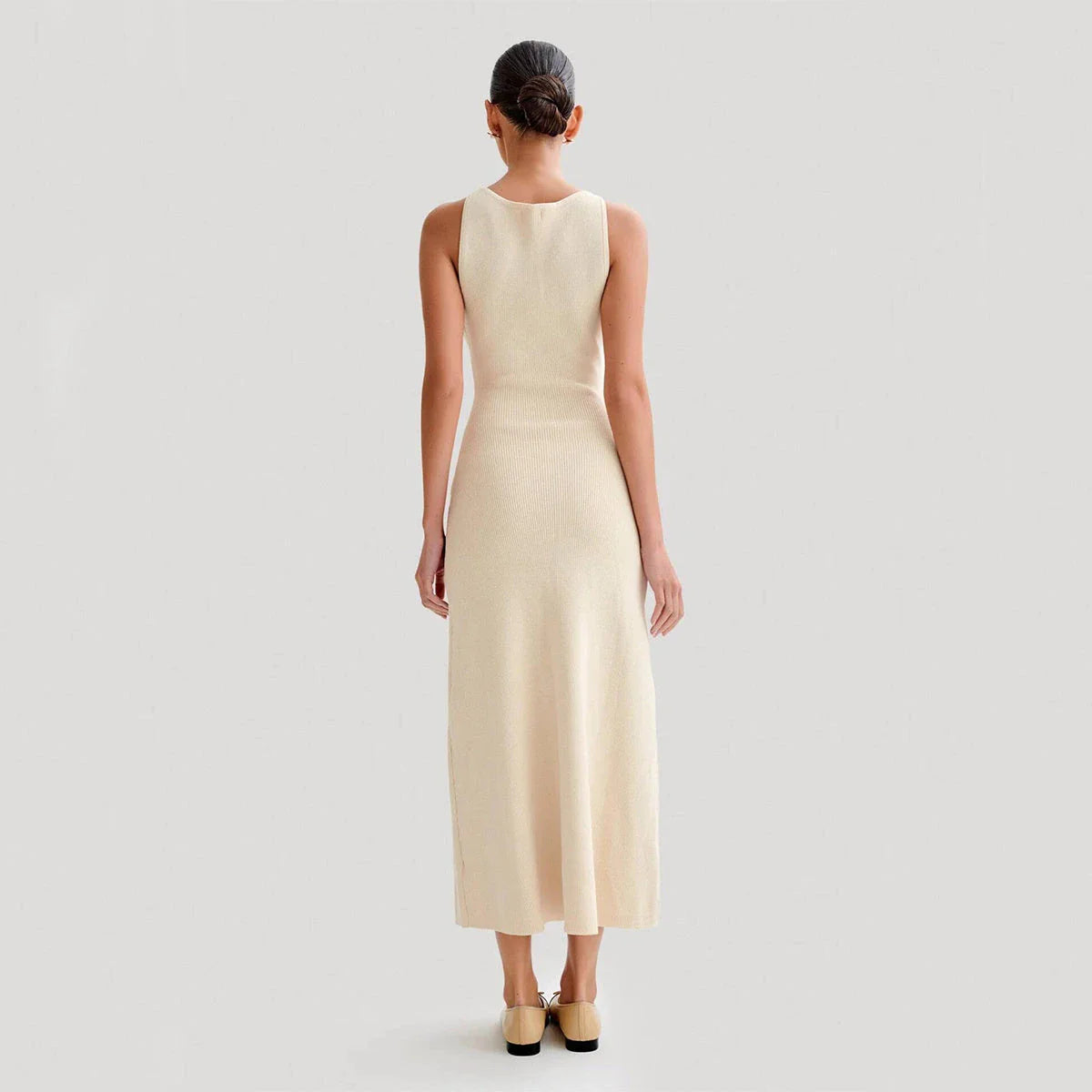 Sleeveless knit dress in apricot and blue colors, showcasing a slim, flattering silhouette and premium polyester construction