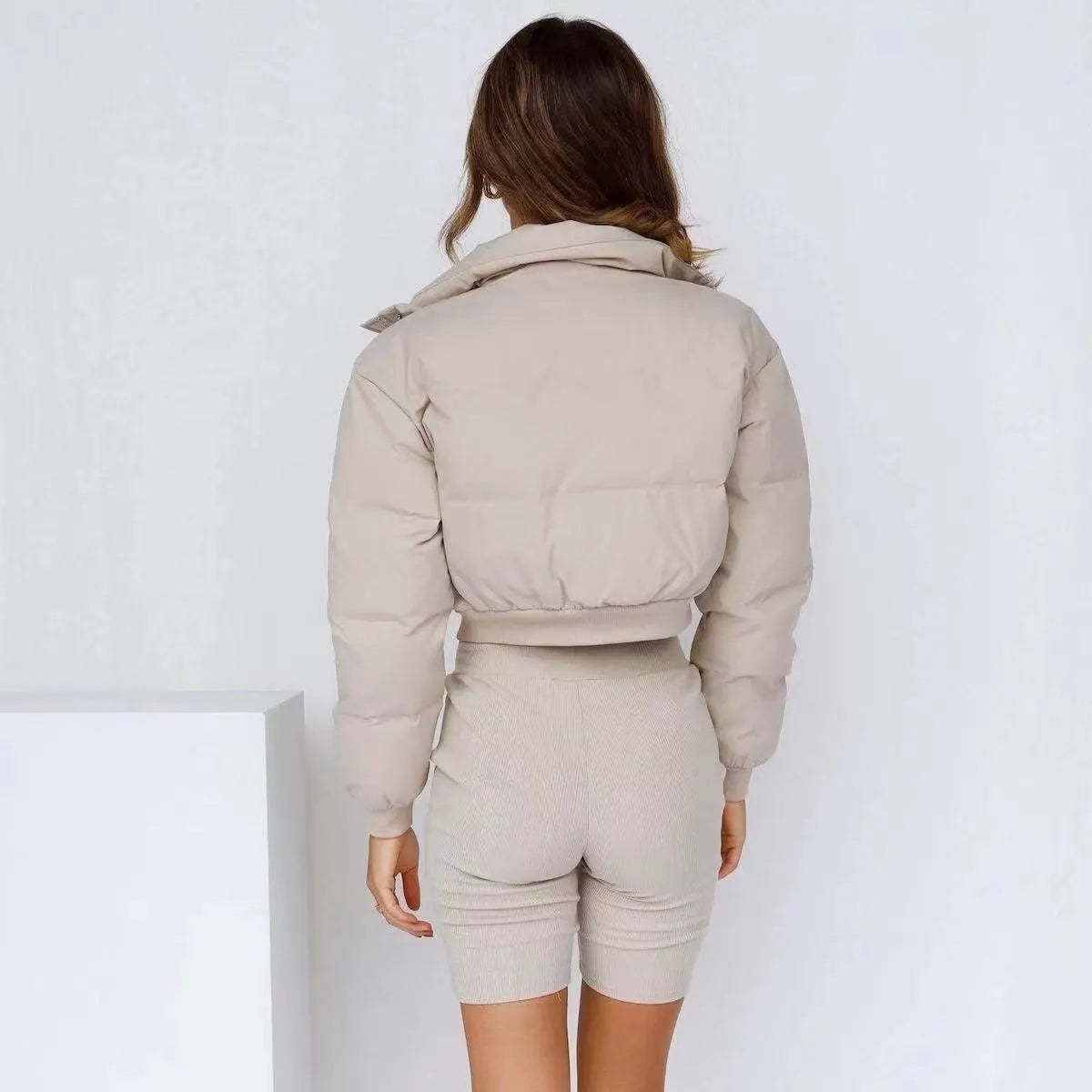 Loose blue polyester jacket for women on a hanger, showing long sleeves and front zip.