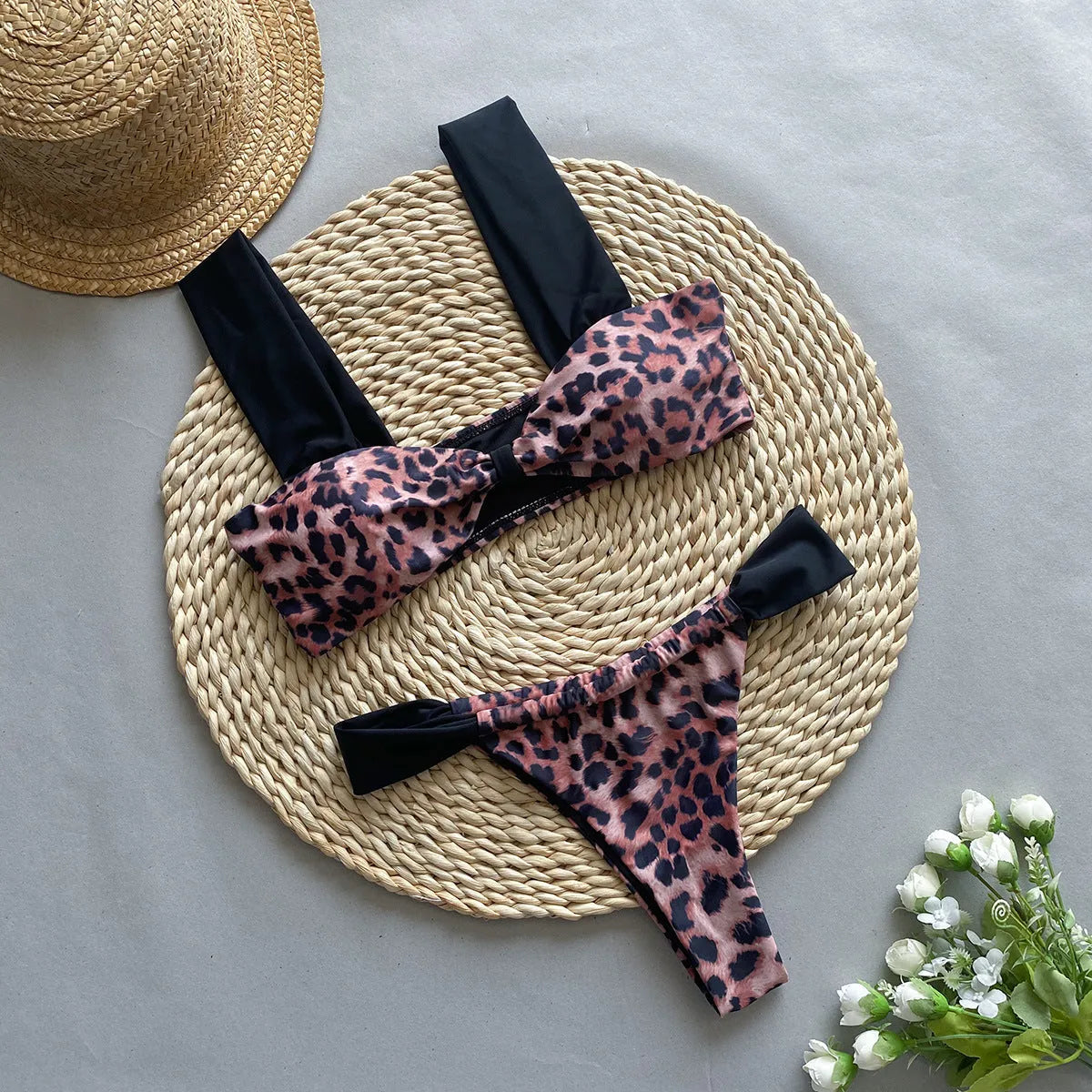 Women's black and leopard print bikini set with tube top and T-pants briefs on a mannequin.