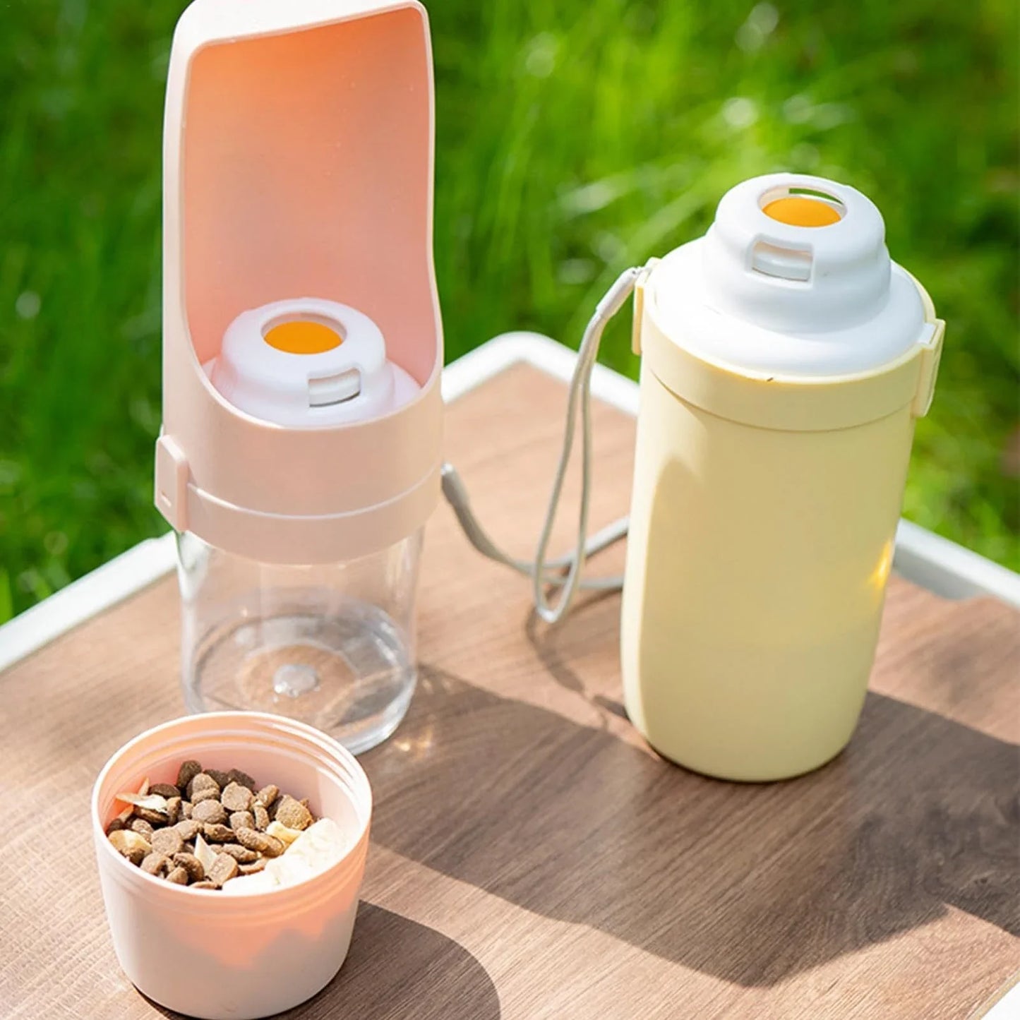 Portable 2-in-1 travel dog water bottle and feeder with lanyard, suitable for outdoor activities with pets