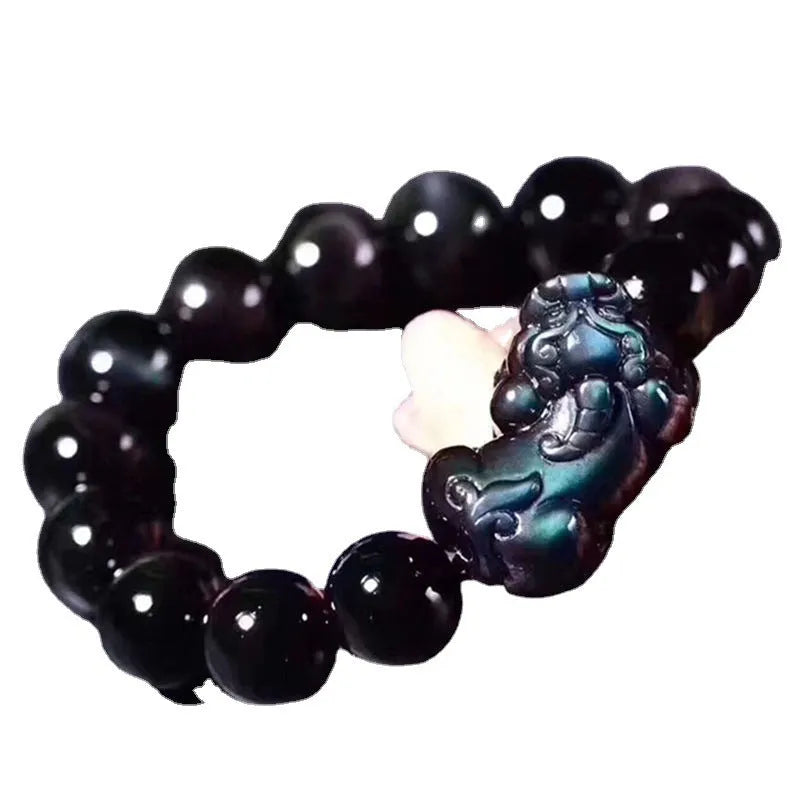Natural Ice Colour Eye Obsidian crystal bracelet on wrist, showing translucent beads.