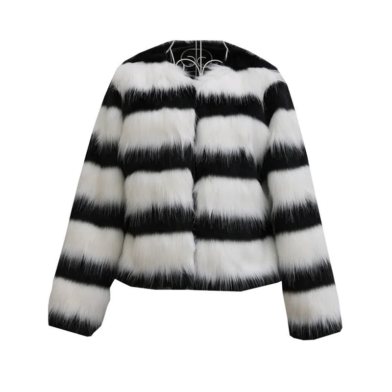 Womens black and white striped long-sleeved faux fur leather jacket on a hanger.