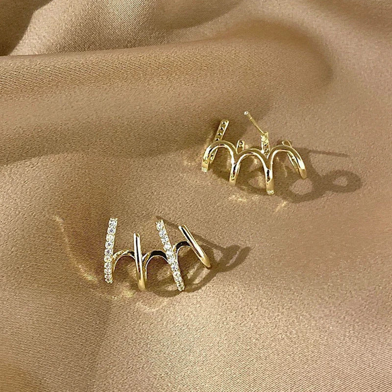 Pair of 925 sterling silver earrings with four-prong zircon stone settings in a geometric design