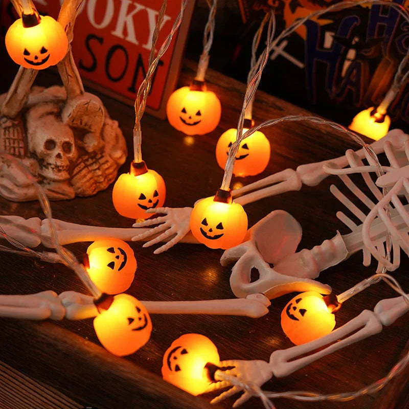 Battery-powered LED Halloween lights in various spooky designs including pumpkins, ghosts, and bats with warm white glow