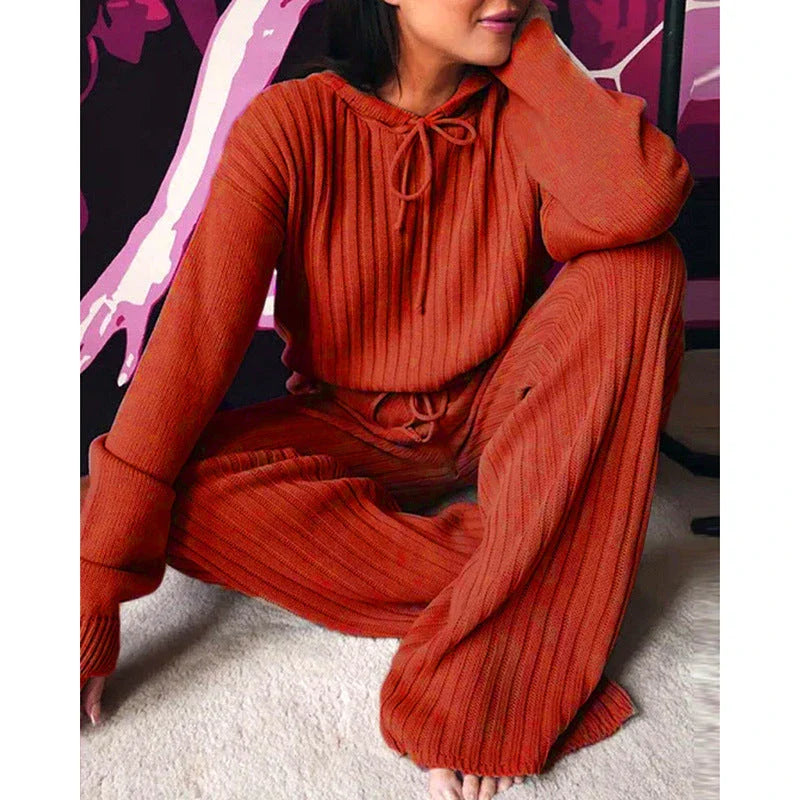 A stylish two-piece casual set featuring a hooded top with long sleeves and matching bottoms in a variety of vibrant colors.