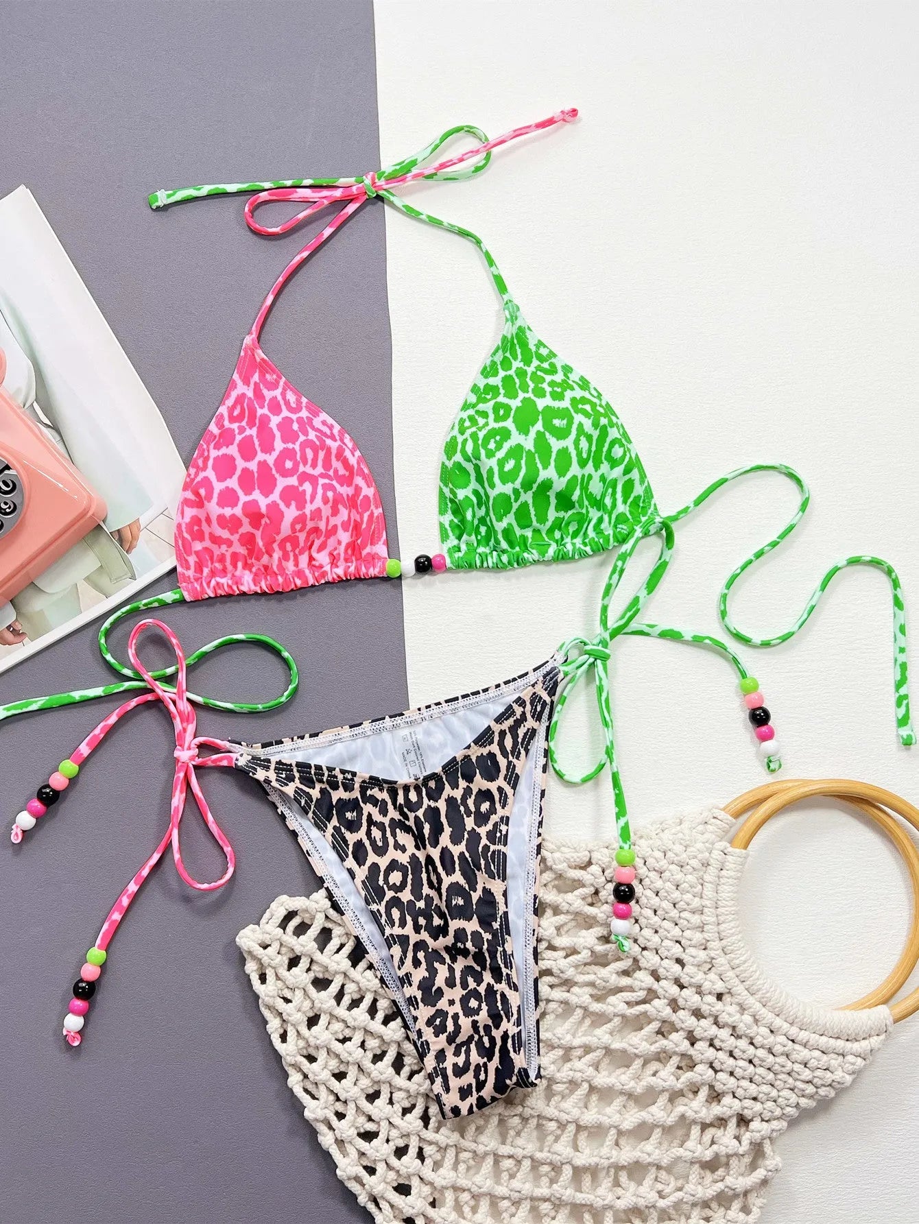 Women's leopard print two-piece bikini swimsuit with bra and briefs on a mannequin.