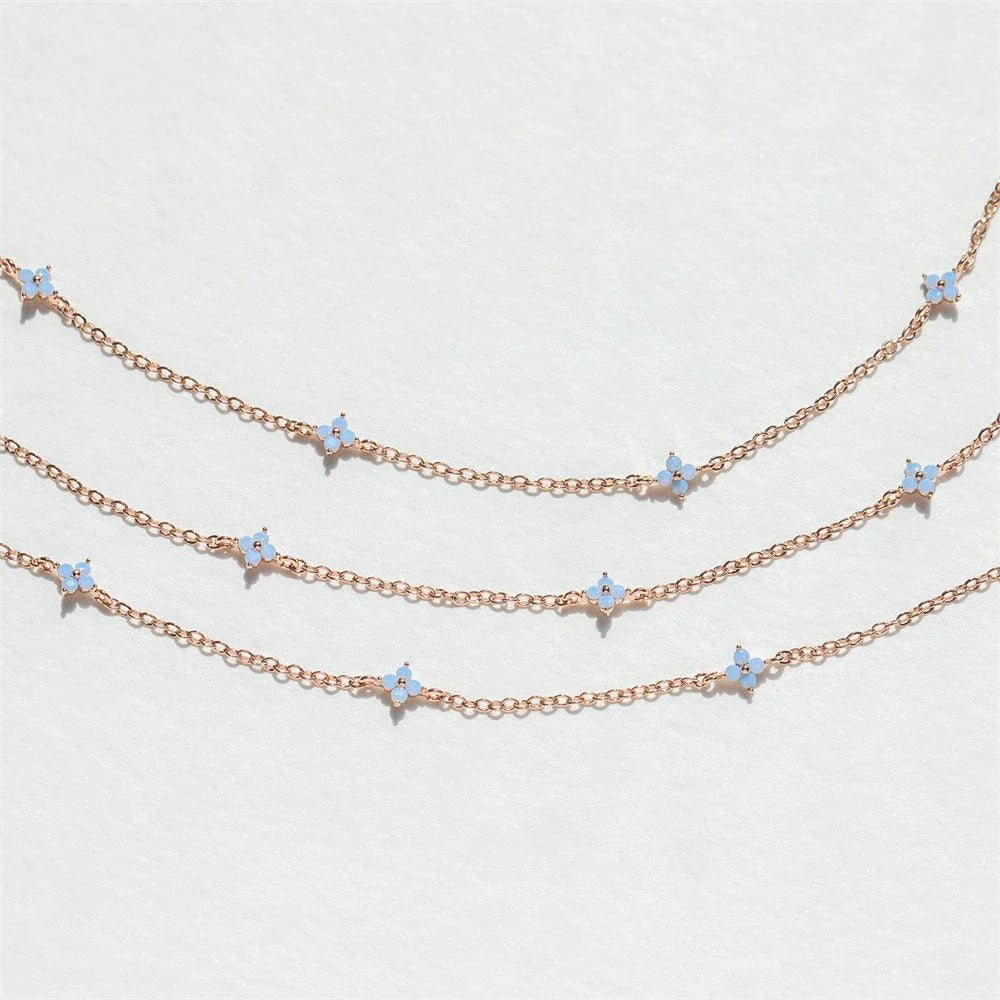 Elegant gold and silver floral necklace with adjustable chain and flower charm, perfect for vacation and beach outfits