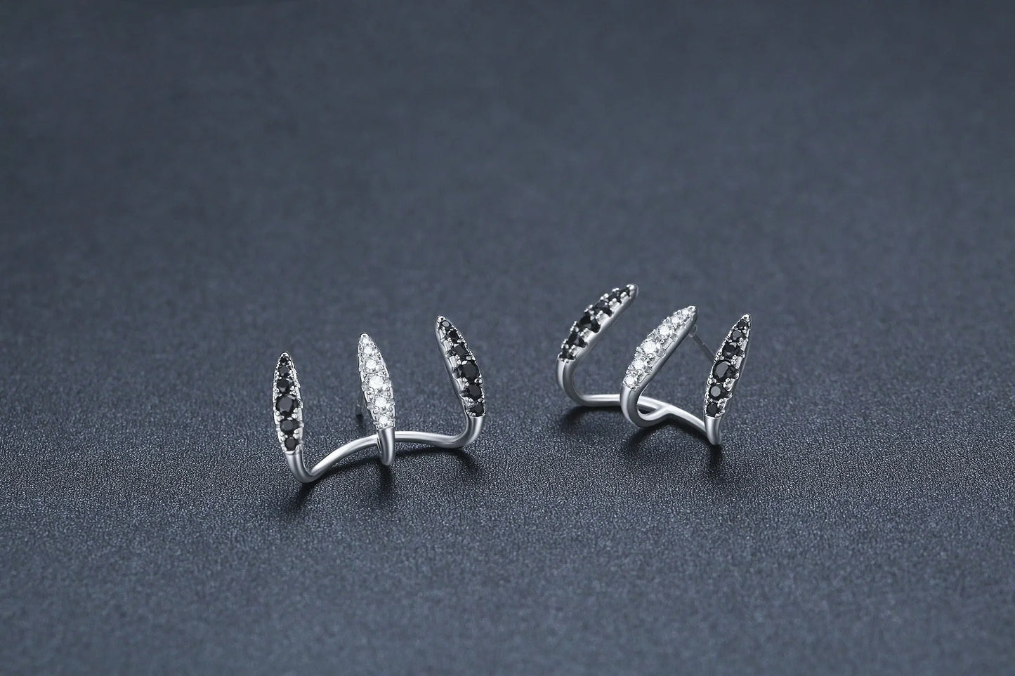 Elegant copper and zircon ear cuffs with a geometric design, showcasing British style and sophistication.