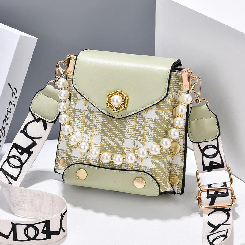 Stylish crossbody bag for women with delicate pearl pendant and adjustable strap for versatile carrying options