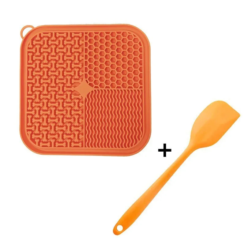 Square orange, grey, blue, and green silicone dog licking mat with suction cups on the base.