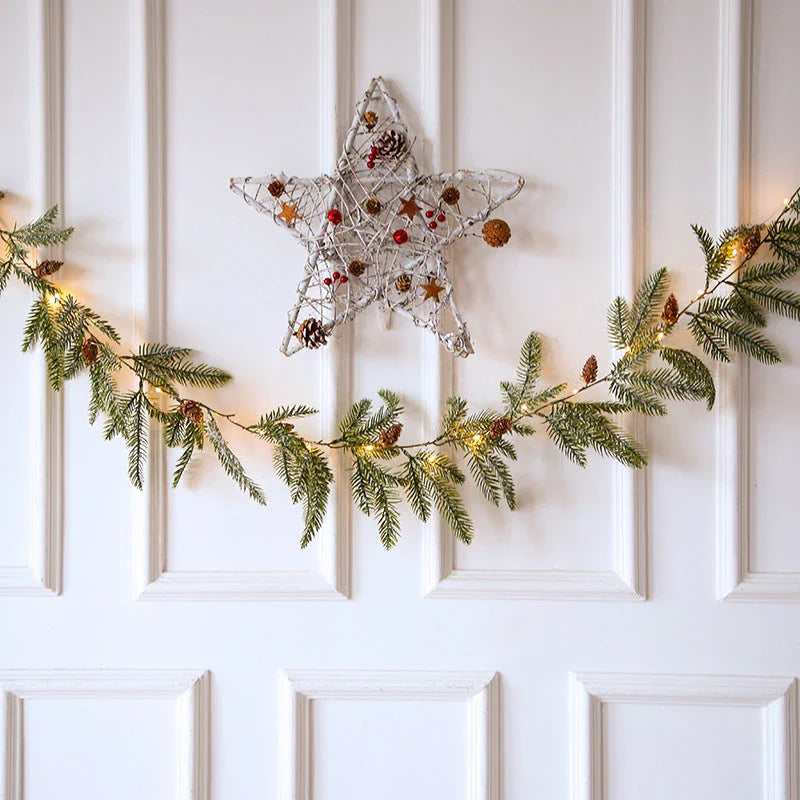 Decorative copper leaf string lights with rattan and pine needle accents, creating a cozy, festive atmosphere