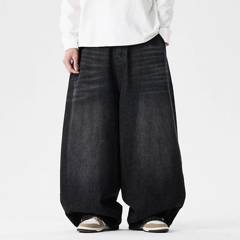 Men's plus-size light blue wide-leg baggy jeans on a neutral background.