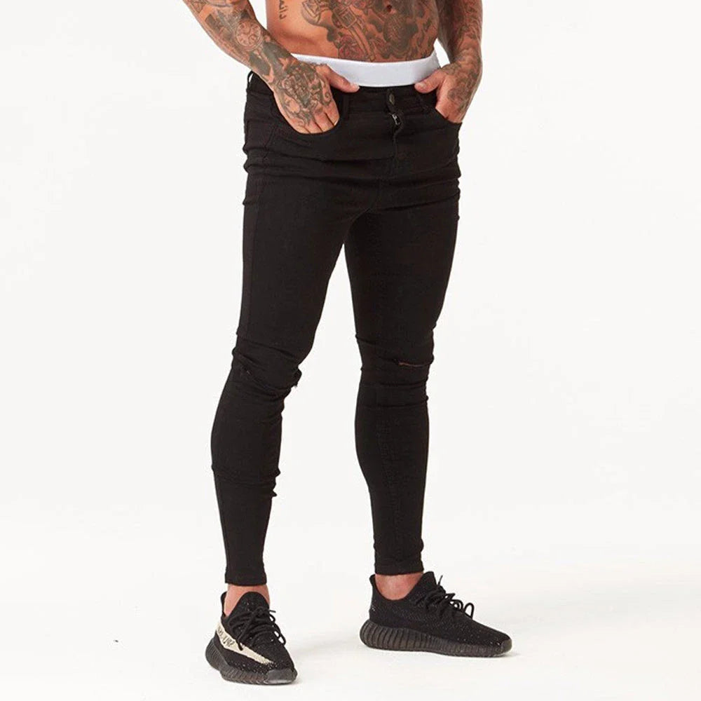Trendy distressed black skinny jeans for men, featuring a super-elastic cotton construction and edgy, lived-in look