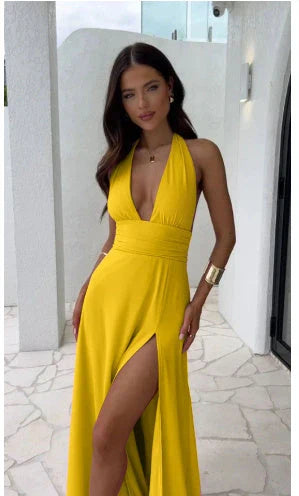 A stylish backless halter neck maxi dress in various colors, featuring a high waist and thigh-high slit for a flattering, eye-catching look.