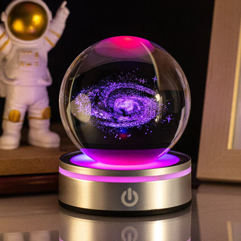 Luminous crystal ball with various celestial-inspired designs, including the Milky Way, Solar System, and Constellation.