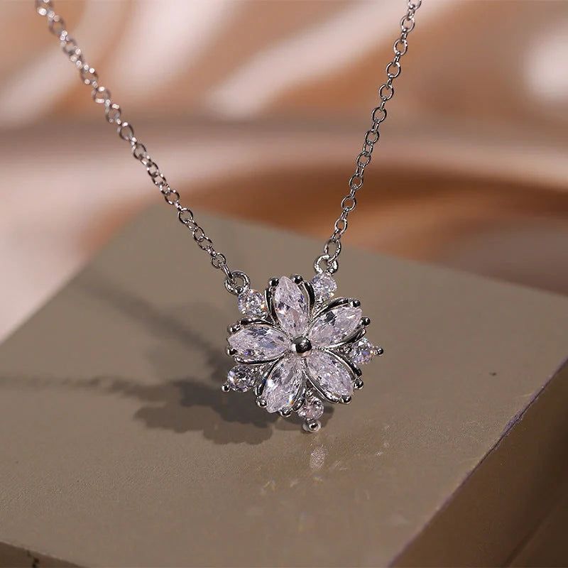 Dazzling cubic zirconia jewellery set with double-layered flower design, including ring, necklace, and earrings in pink and white diamond colours