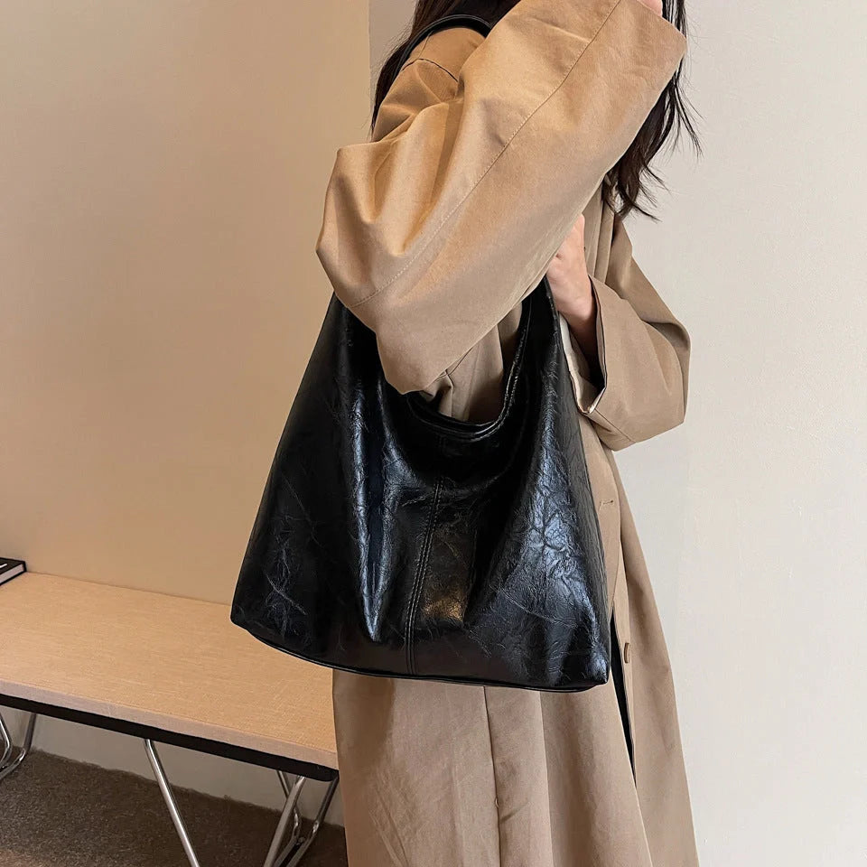 Classic vintage-inspired women's shoulder bag in a range of sophisticated colours, featuring a roomy interior, adjustable strap, and premium materials for timeless British style.