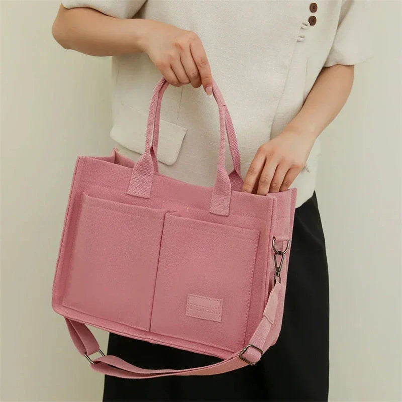 Premium canvas tote bag with multiple pockets, adjustable shoulder strap, and stylish design for everyday use