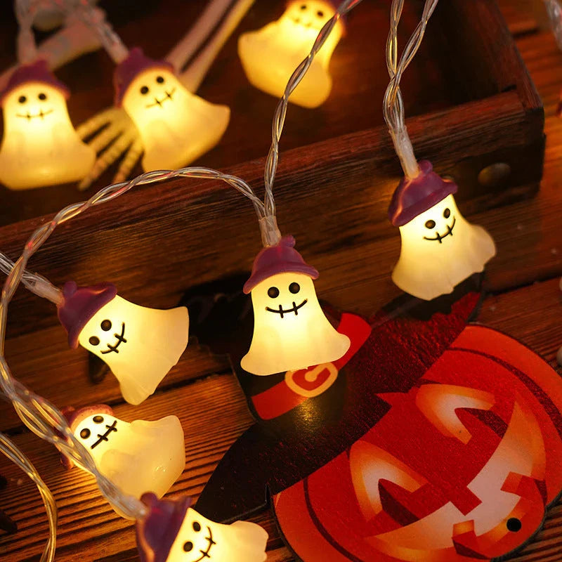 Battery-powered LED Halloween lights in various spooky designs including pumpkins, ghosts, and bats with warm white glow