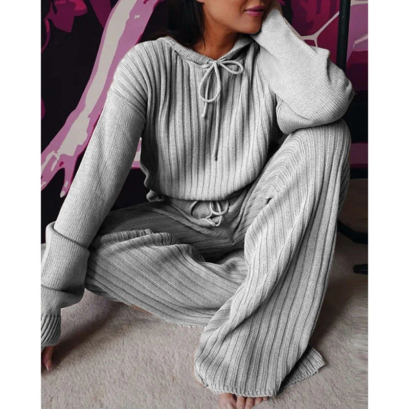 A stylish two-piece casual set featuring a hooded top with long sleeves and matching bottoms in a variety of vibrant colors.