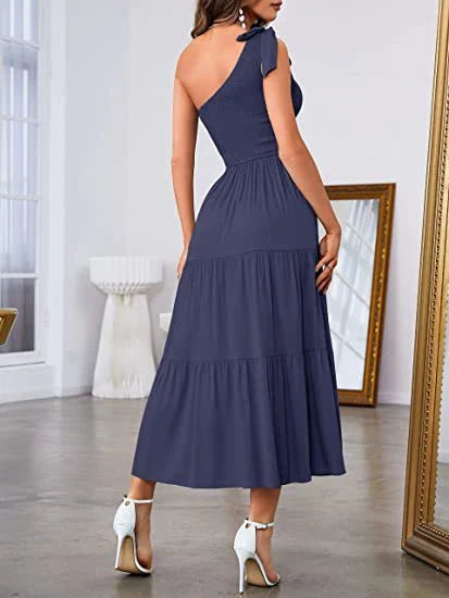 Elegant one-shoulder pleated maxi dress in various colours, featuring an asymmetrical hem and side slits for a stylish, head-turning look