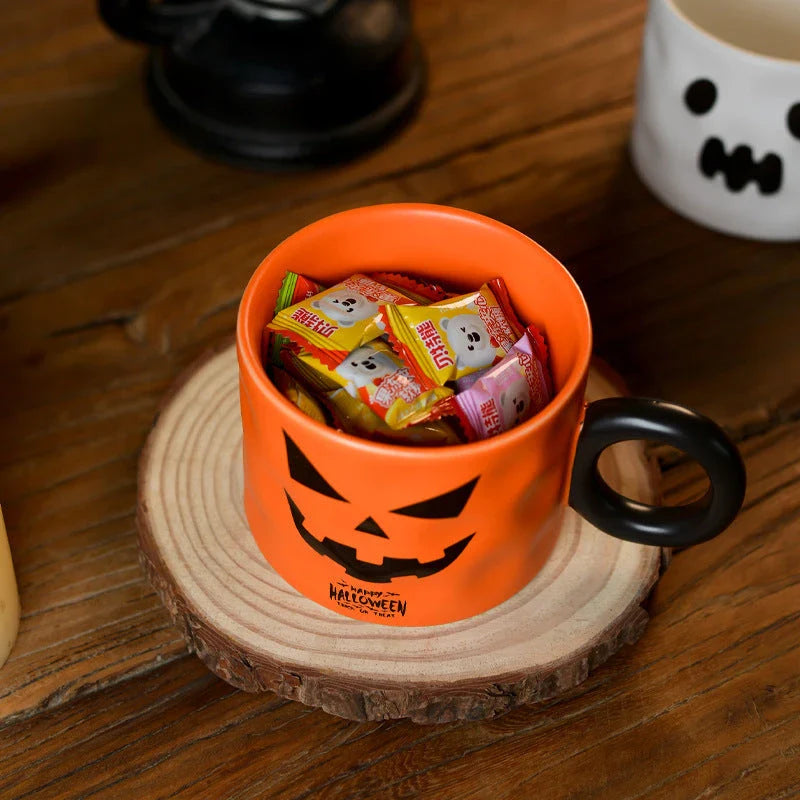 Festive pumpkin-themed ceramic mugs in orange and white colors, perfect for Halloween celebrations and enjoying hot or cold beverages