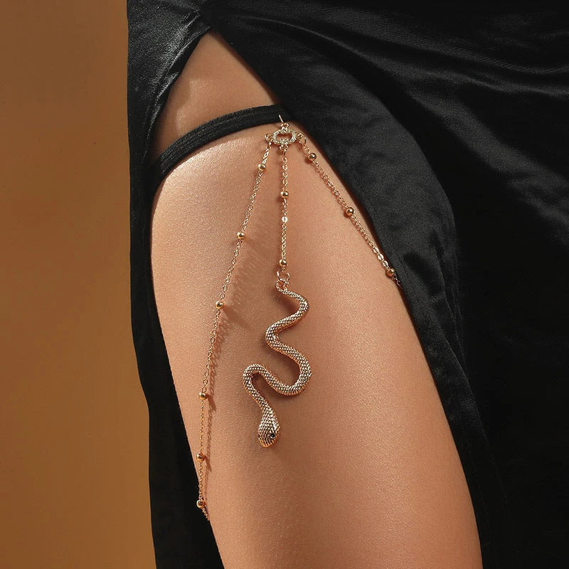 Fashionable gold beaded leg chain with snake pendant for women, featuring a captivating design and adjustable fit for comfortable wear.