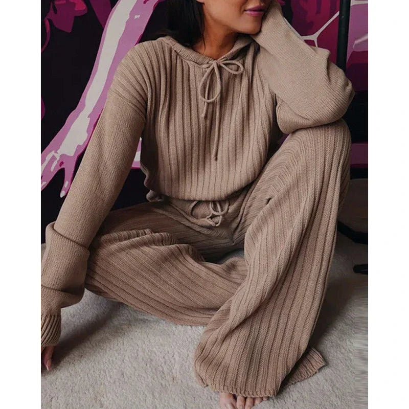 A stylish two-piece casual set featuring a hooded top with long sleeves and matching bottoms in a variety of vibrant colors.