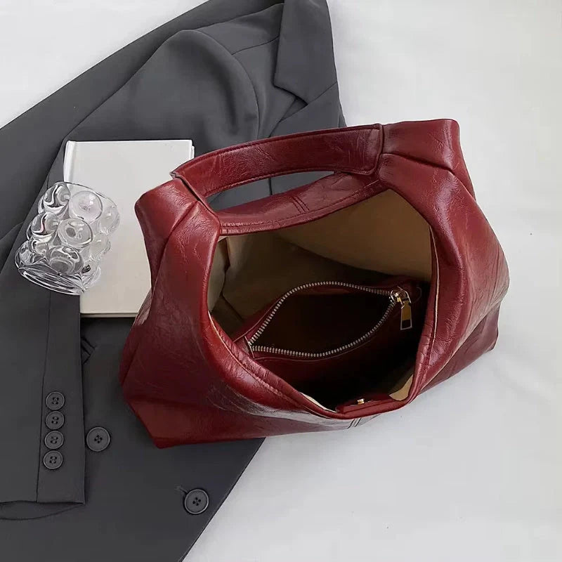 Classic vintage-inspired women's shoulder bag in a range of sophisticated colours, featuring a roomy interior, adjustable strap, and premium materials for timeless British style.