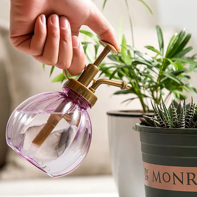 A stylish garden sprayer in a pumpkin shape with a retro-inspired copper pressure bar, designed for watering flowers and plants efficiently.