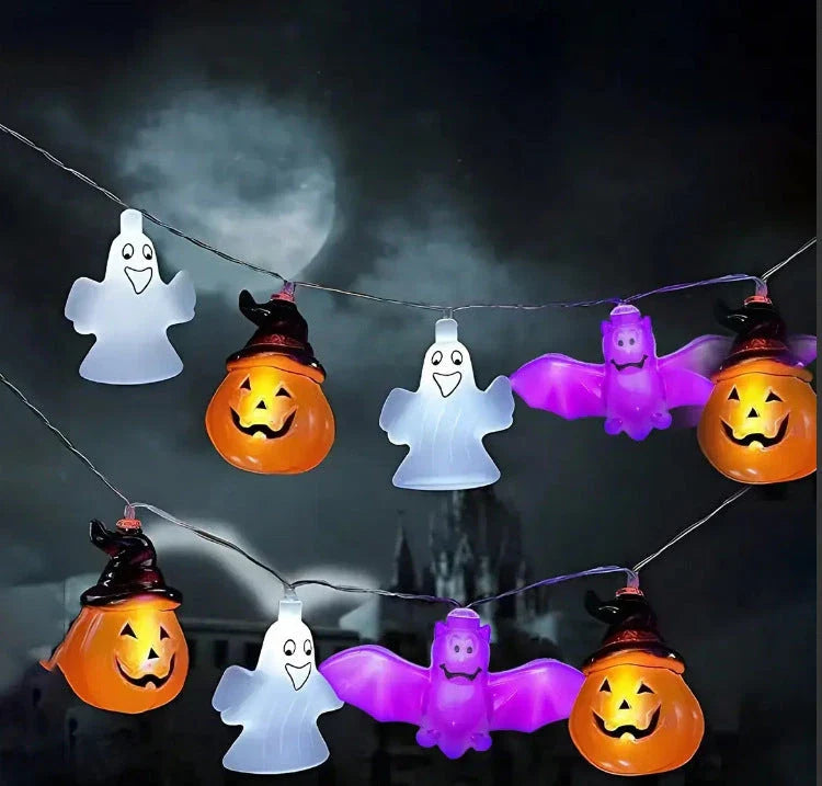 Battery-powered LED Halloween lights in various spooky designs including pumpkins, ghosts, and bats with warm white glow