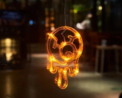 Spooky Halloween window lights featuring ghostly silhouettes, carved pumpkins, and creepy spiders for festive seasonal decor