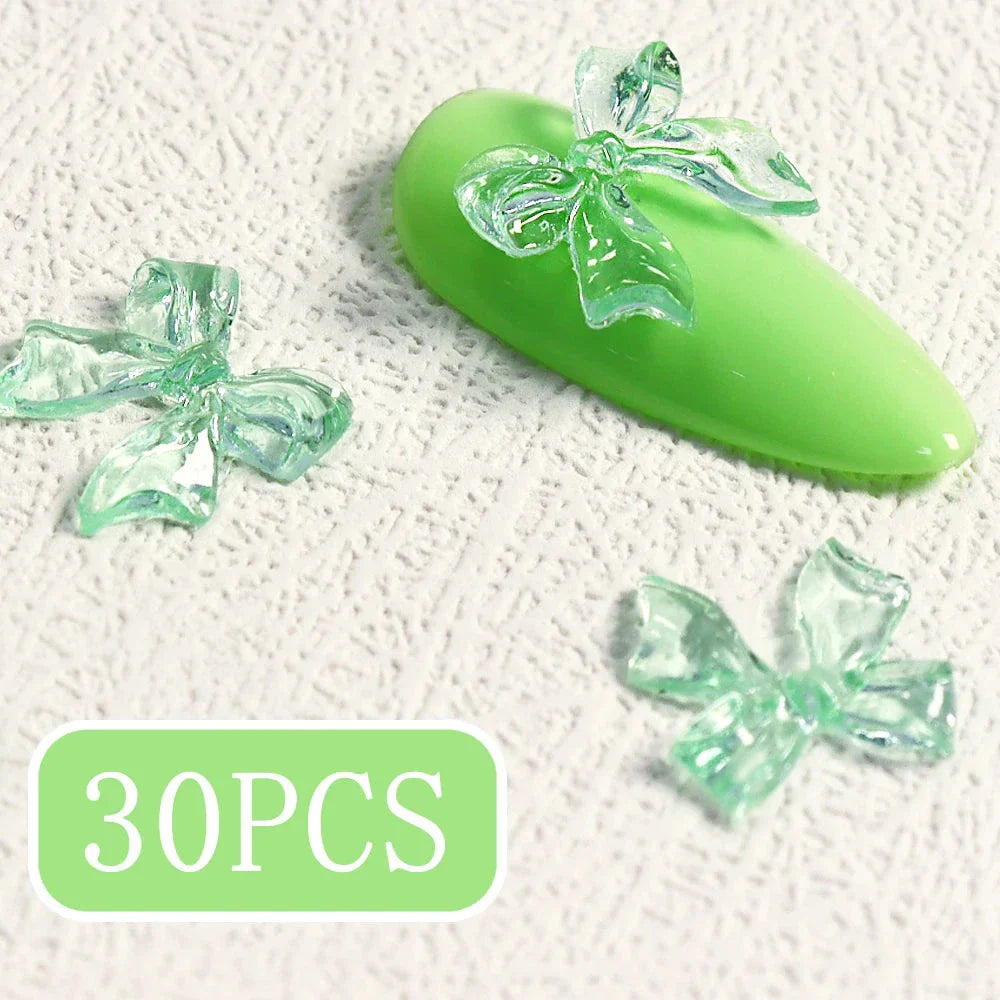 Charming candy-coloured bow nail charms in various colours, perfect for adding a playful touch to your manicure