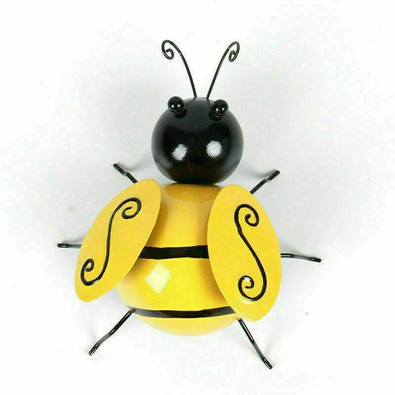 Four decorative metal bumble bee sculptures in a natural garden setting