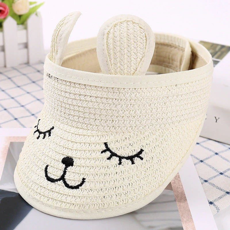 Rabbit-themed straw sun hat for kids with adjustable strap and foldable design for portability