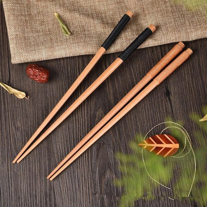 Pair of natural chestnut wood chopsticks with a rustic, earthy tone and elegant design