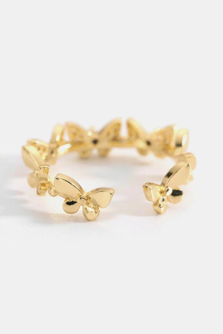 Elegant gold-toned open ring with a captivating butterfly design accented by sparkling zircon stones